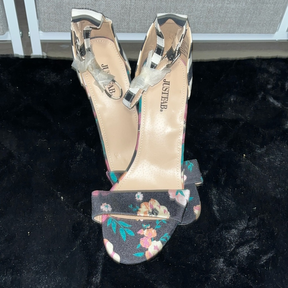 Floral heels with a black and white stripped heel, Never worn!